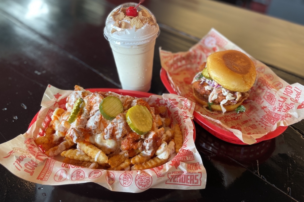 The photo features the Buffalo Mac fries ($13.99), the Tenders Sando ($11.49) and the Cinnamon Toast Crunch milkshake ($6.99). (Sienna Wight/Community Impact)